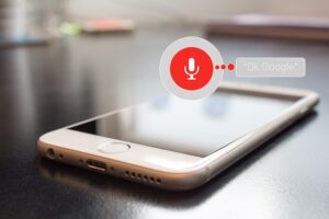 Atlanta small business owner using voice search optimization on a smartphone